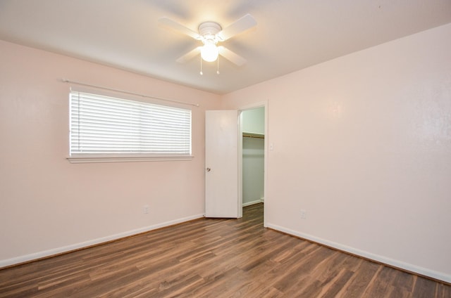 spare room featuring ceiling fan and dark wood-type flooring