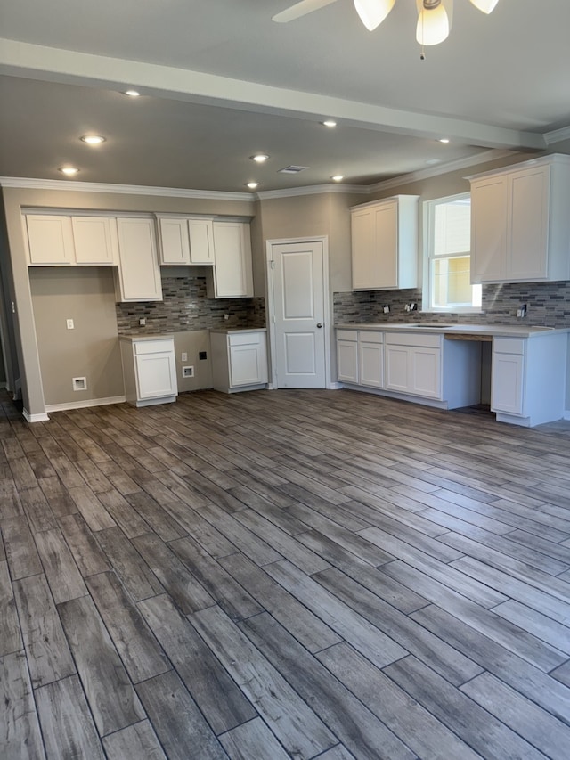 kitchen featuring hardwood / wood-style floors, white cabinets, and ornamental molding