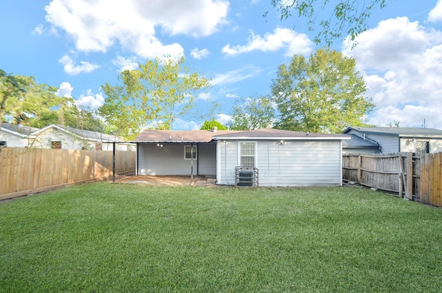 rear view of property with a yard