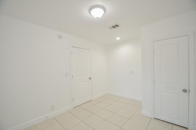 unfurnished room with light tile patterned floors