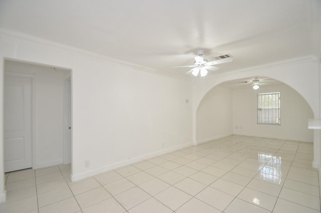 tiled spare room featuring ceiling fan and crown molding