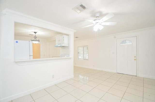 unfurnished room featuring crown molding, ceiling fan, and light tile patterned floors