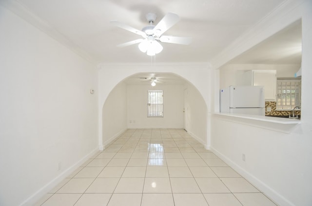 spare room featuring sink, ceiling fan, crown molding, and light tile patterned flooring