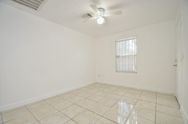 tiled spare room featuring ceiling fan