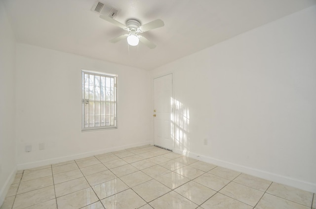 tiled empty room with ceiling fan