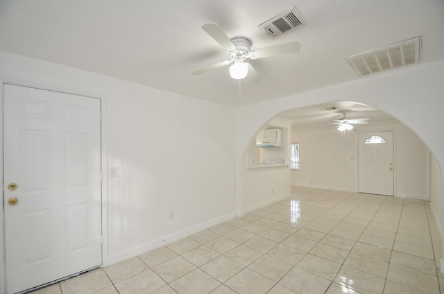 spare room featuring ceiling fan and light tile patterned floors