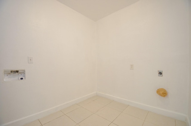 clothes washing area featuring hookup for an electric dryer, hookup for a washing machine, and light tile patterned floors