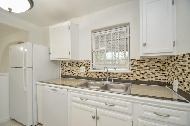 kitchen with white appliances, backsplash, white cabinetry, and sink