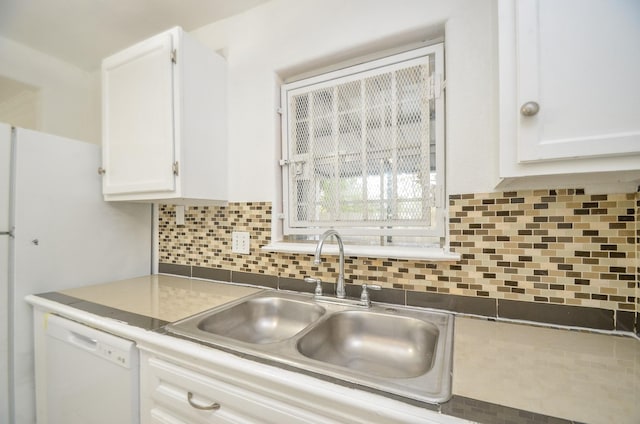 kitchen featuring backsplash, white cabinetry, sink, and white dishwasher