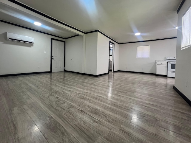 interior space featuring a wall mounted air conditioner, light hardwood / wood-style floors, and ornamental molding