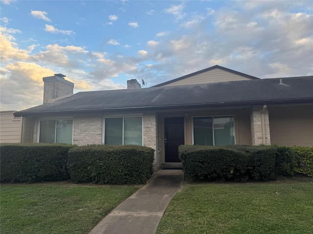 ranch-style home with a front lawn