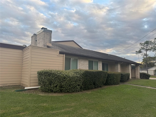 view of side of property with a lawn