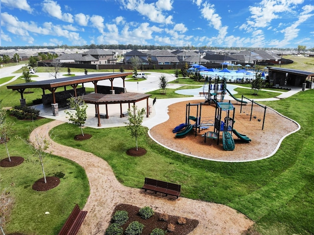 view of home's community featuring a playground and a yard