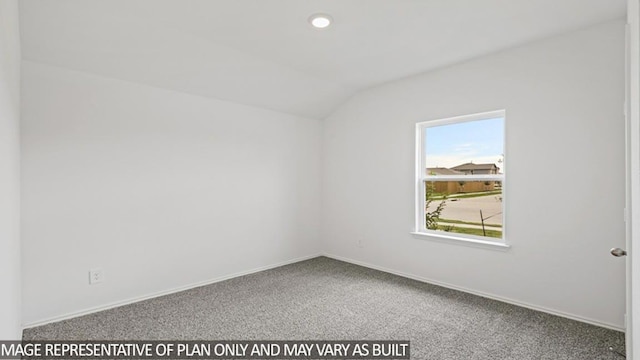 empty room featuring carpet and vaulted ceiling