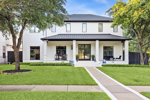 exterior space featuring covered porch and a front yard