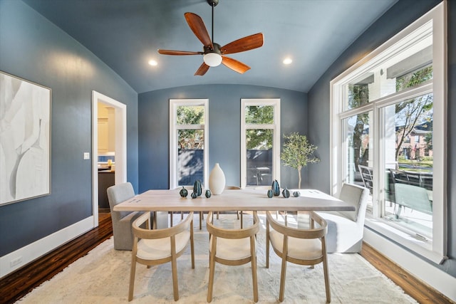 dining space with hardwood / wood-style flooring, ceiling fan, and lofted ceiling