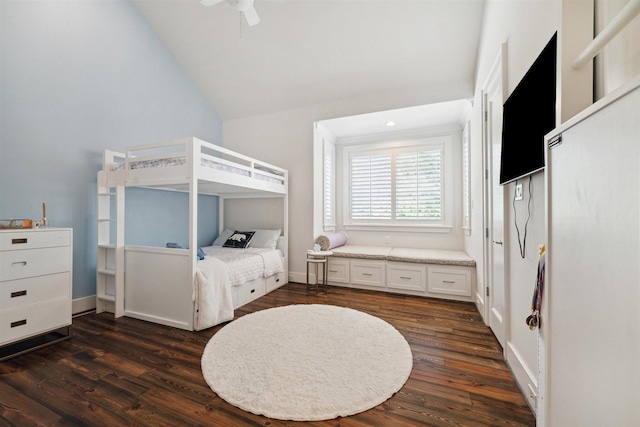 bedroom featuring ceiling fan, dark wood-type flooring, and vaulted ceiling