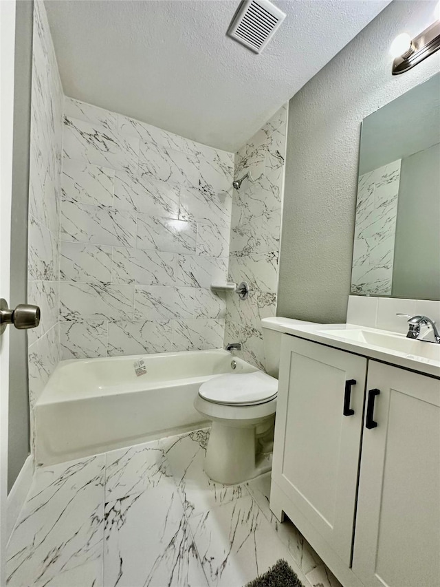 full bathroom with a textured ceiling, vanity, toilet, and tiled shower / bath combo