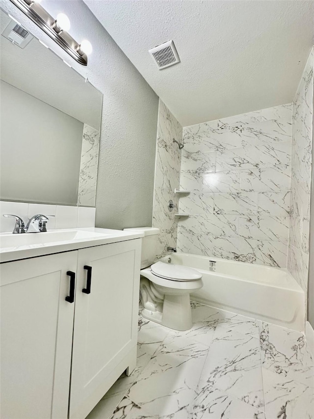 full bathroom with a textured ceiling, vanity, tiled shower / bath combo, and toilet