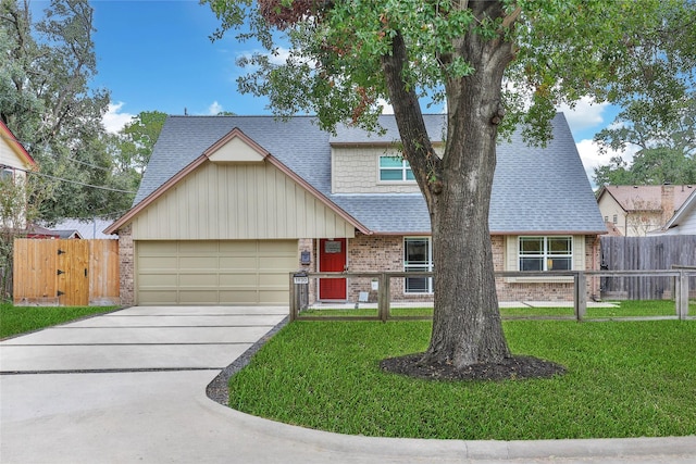 view of front of house with a front yard and a garage