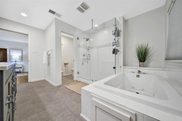 bathroom featuring toilet and independent shower and bath