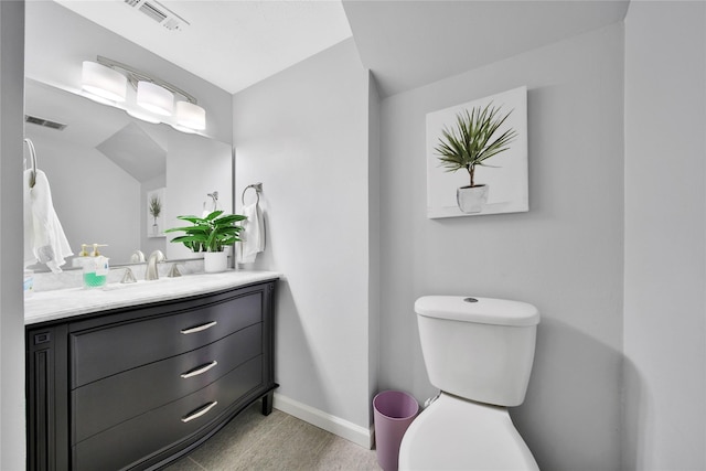 bathroom with vanity, hardwood / wood-style flooring, and toilet