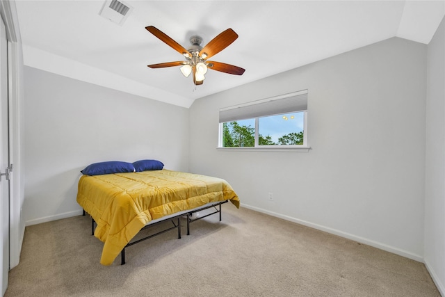 carpeted bedroom featuring ceiling fan and vaulted ceiling