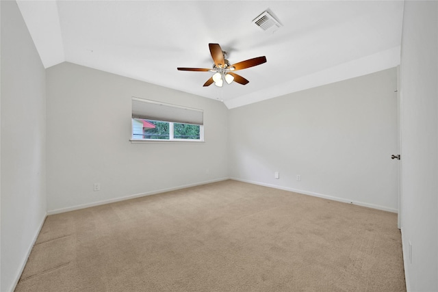 unfurnished room with ceiling fan, light colored carpet, and vaulted ceiling