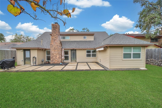 rear view of house featuring a patio area and a lawn