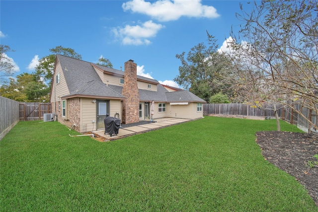 back of property featuring a yard, cooling unit, and a patio area