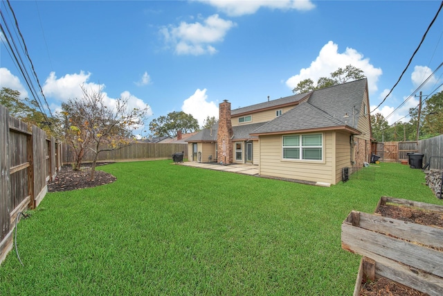 back of property featuring a patio area and a yard