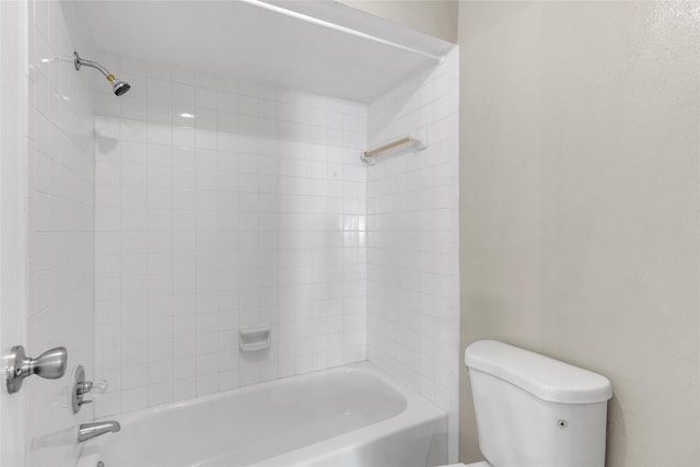 bathroom with tiled shower / bath combo and toilet