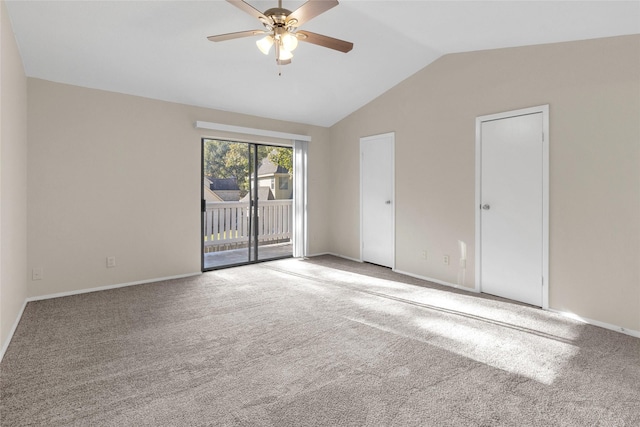 empty room featuring ceiling fan, carpet floors, and vaulted ceiling