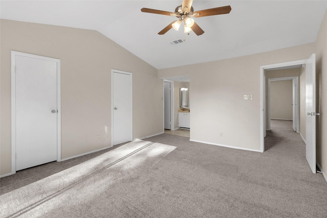 unfurnished bedroom featuring ceiling fan, light carpet, and vaulted ceiling