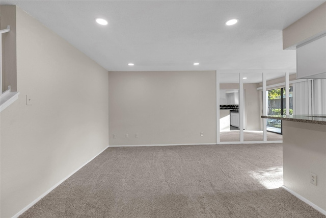 unfurnished living room with carpet flooring