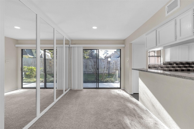 unfurnished living room with light carpet