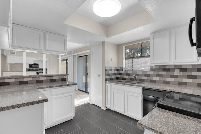 kitchen featuring white cabinetry, sink, a raised ceiling, decorative backsplash, and black appliances