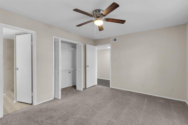 unfurnished bedroom with light colored carpet and ceiling fan