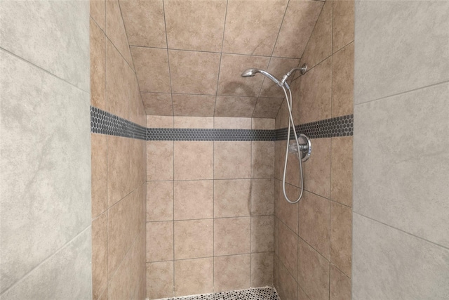 interior details with a tile shower