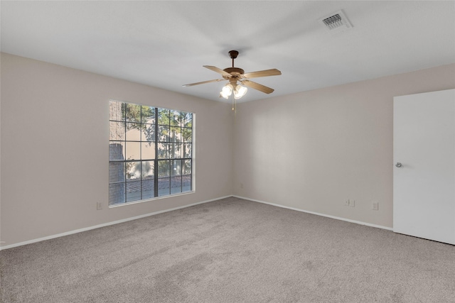 spare room featuring carpet flooring and ceiling fan