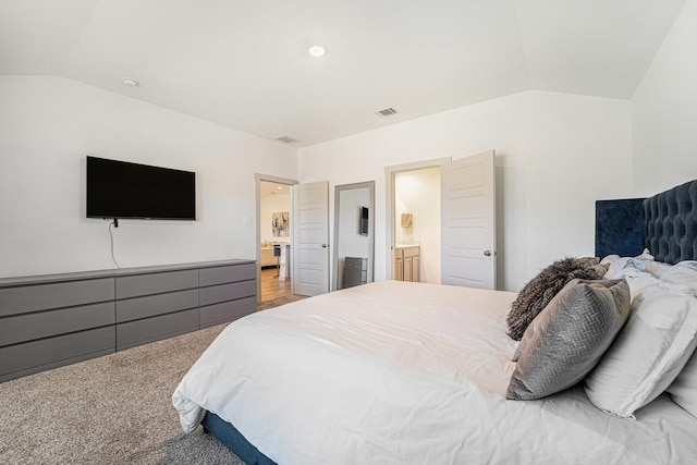 carpeted bedroom featuring connected bathroom and vaulted ceiling