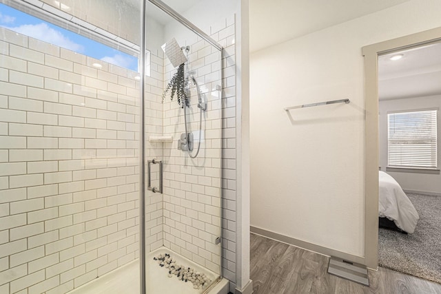 bathroom featuring wood-type flooring and an enclosed shower