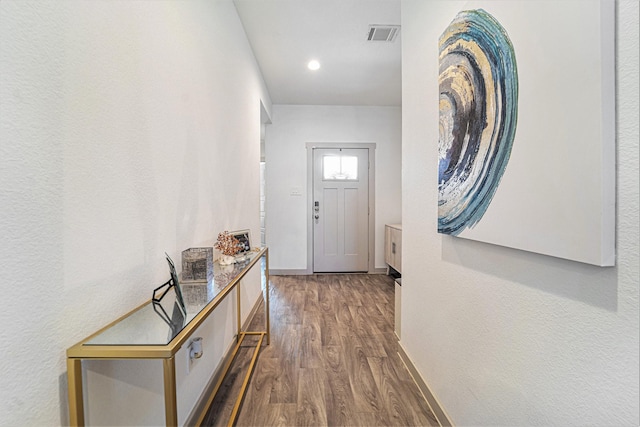 entryway with dark hardwood / wood-style flooring