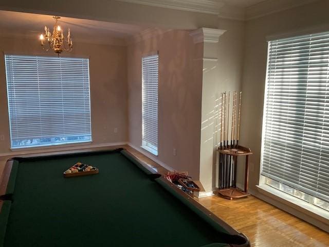 recreation room featuring an inviting chandelier, crown molding, billiards, plenty of natural light, and wood-type flooring