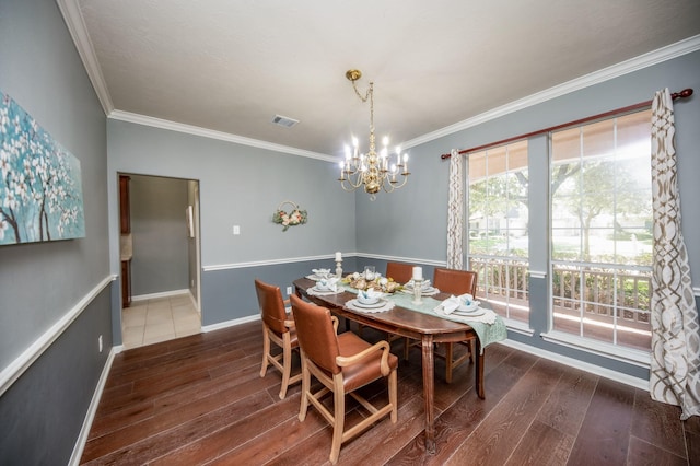 dining room featuring crown molding, dark hardwood / wood-style flooring, and a notable chandelier