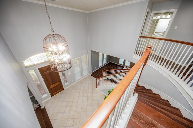 entryway featuring a chandelier, hardwood / wood-style flooring, and crown molding