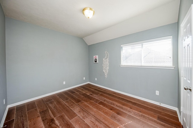 unfurnished room with lofted ceiling and dark hardwood / wood-style floors