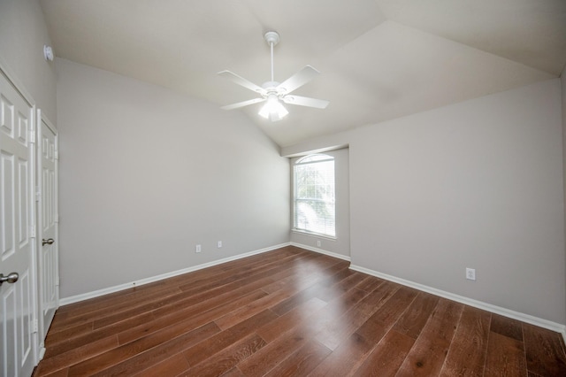 spare room featuring dark hardwood / wood-style floors, ceiling fan, and lofted ceiling