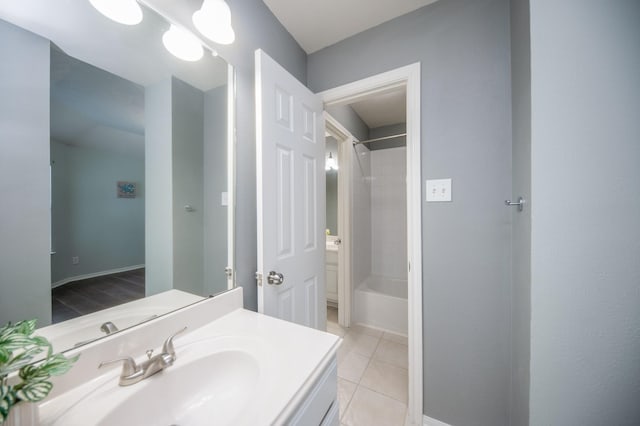 bathroom featuring vanity, tiled shower / bath combo, and tile patterned floors