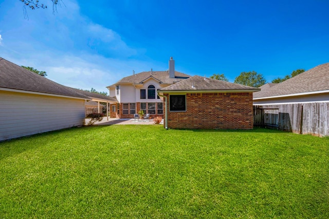 rear view of property featuring a patio area and a yard